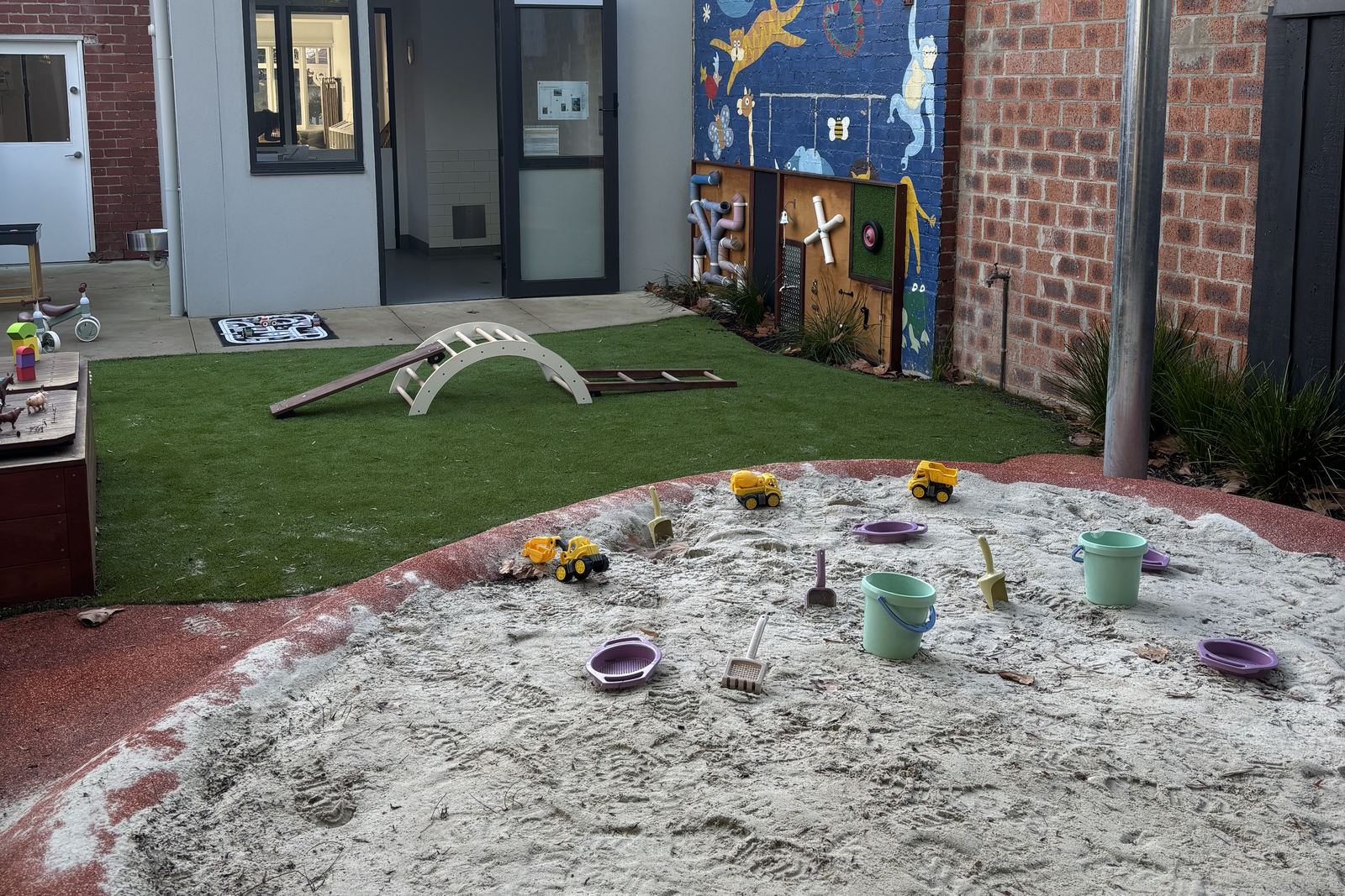 The sandpit with toy trucks
