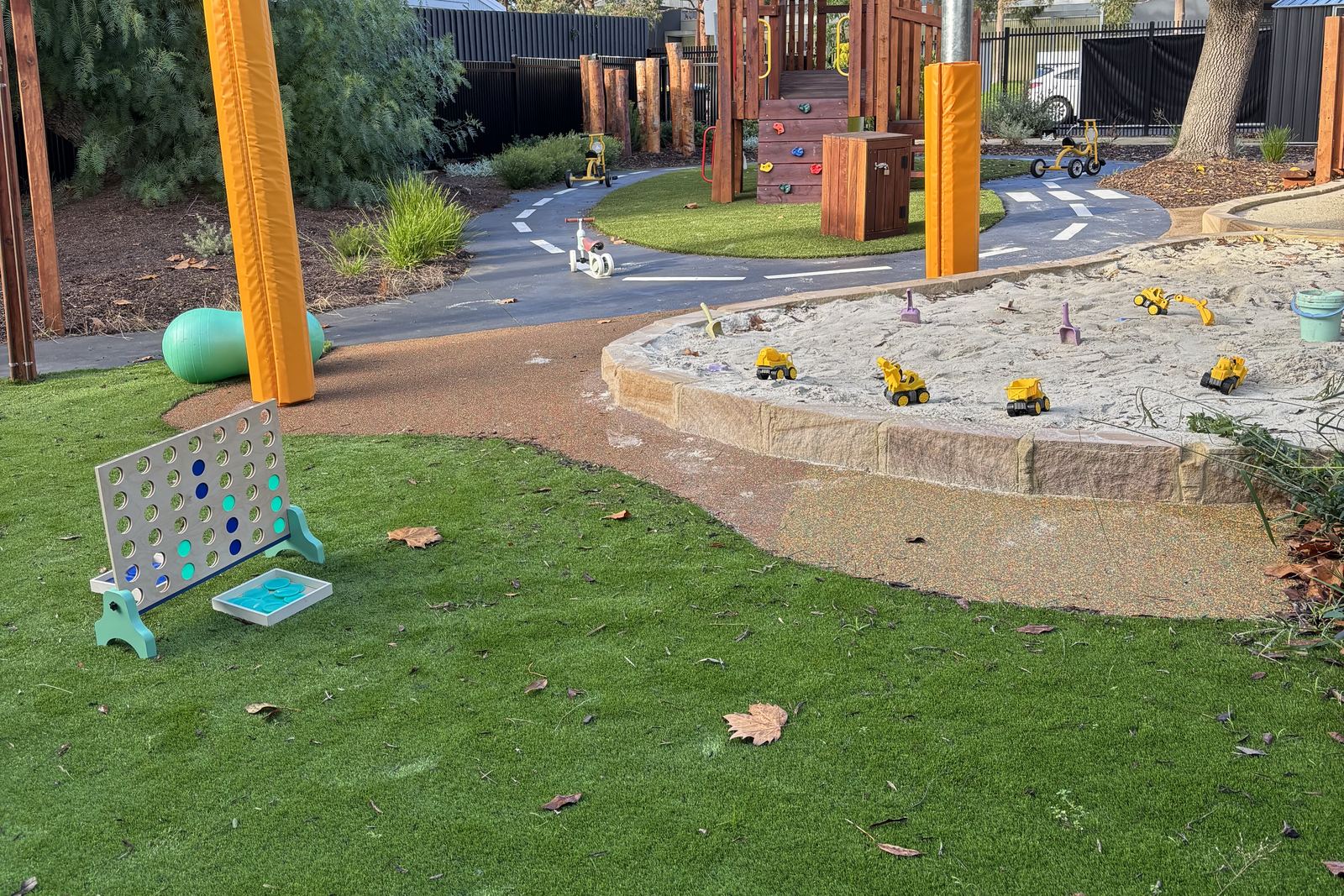Shade sails over the sandpit and lawn